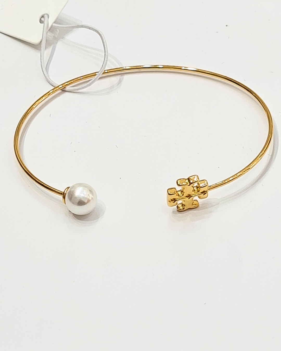 elegant gold toned hinged logo bangle