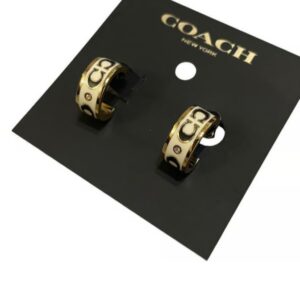 coach signature enamel huggie earrings in gold and white