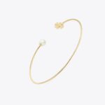 elegant gold toned hinged logo bangle