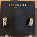 coach signature enamel huggie earrings in gold and white